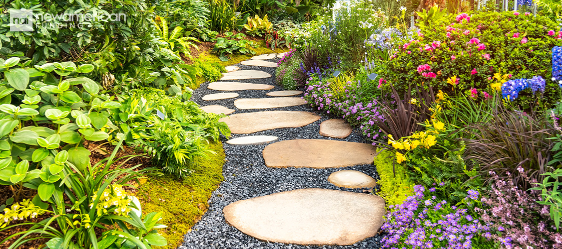A stone path in a flowering garden.