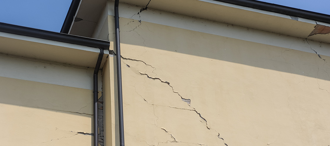 A big crack in the exterior of a home.