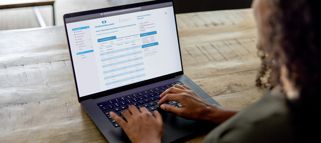 A person reviewing their financial information on a laptop