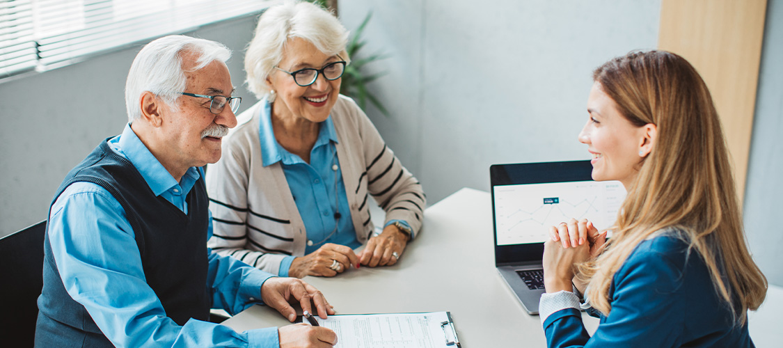 An older couple meeting with a loan officer
