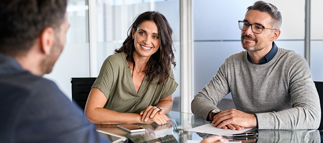A couple talking with a loan officer