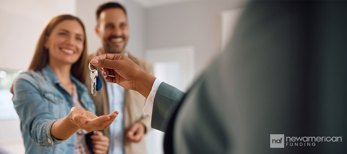 A couple getting the keys to their new home.