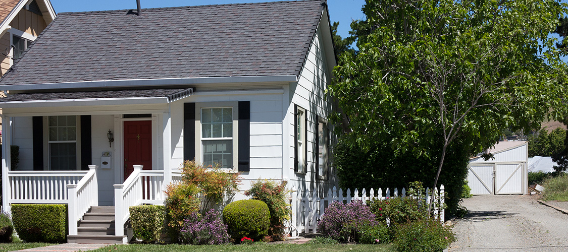 A craftsman house that is painted white