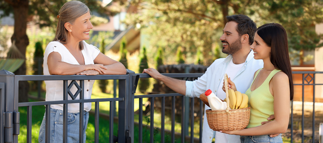 A couple offering food to a neighbor