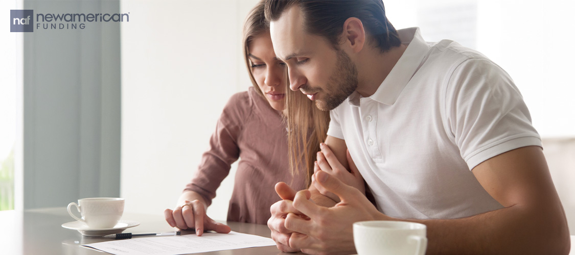 A couple looking at paperwork.