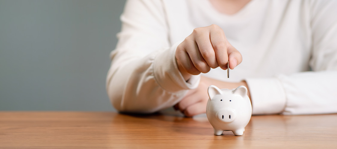 Putting money in a piggy bank