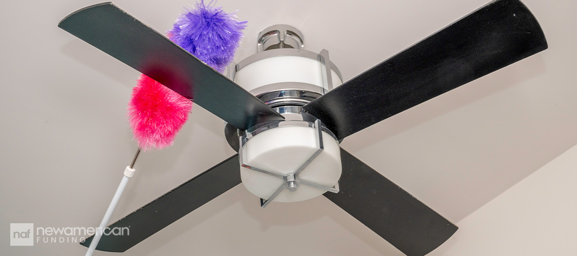 Someone dusting a ceiling fan.