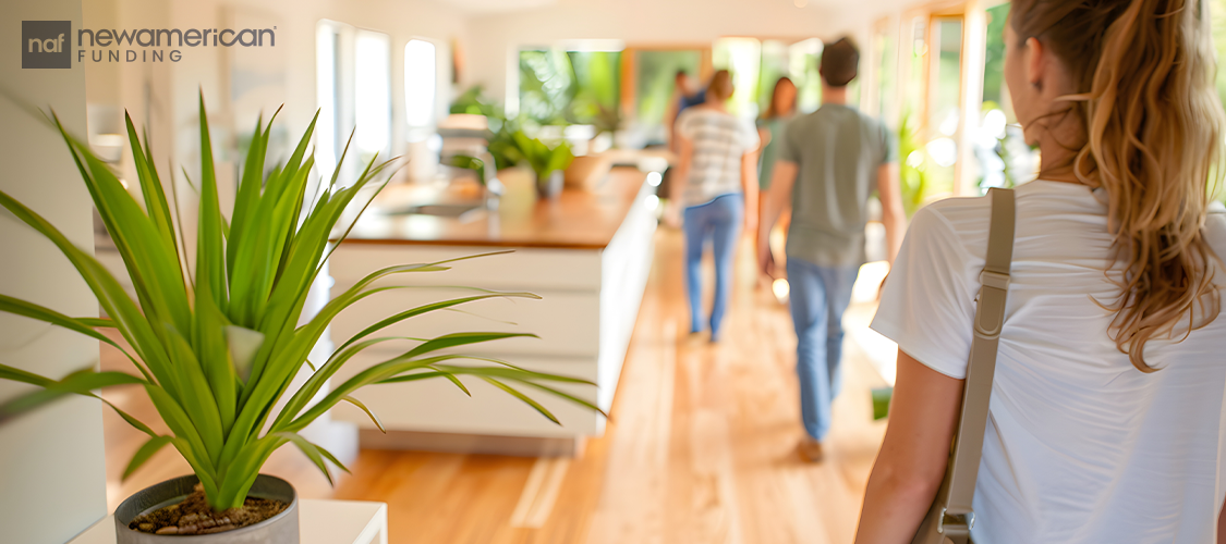 People walking through a house.