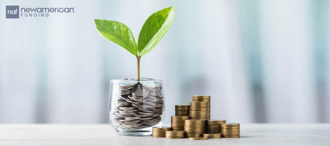 A plant growing out of a jar of coins with more coins next to it on the table.