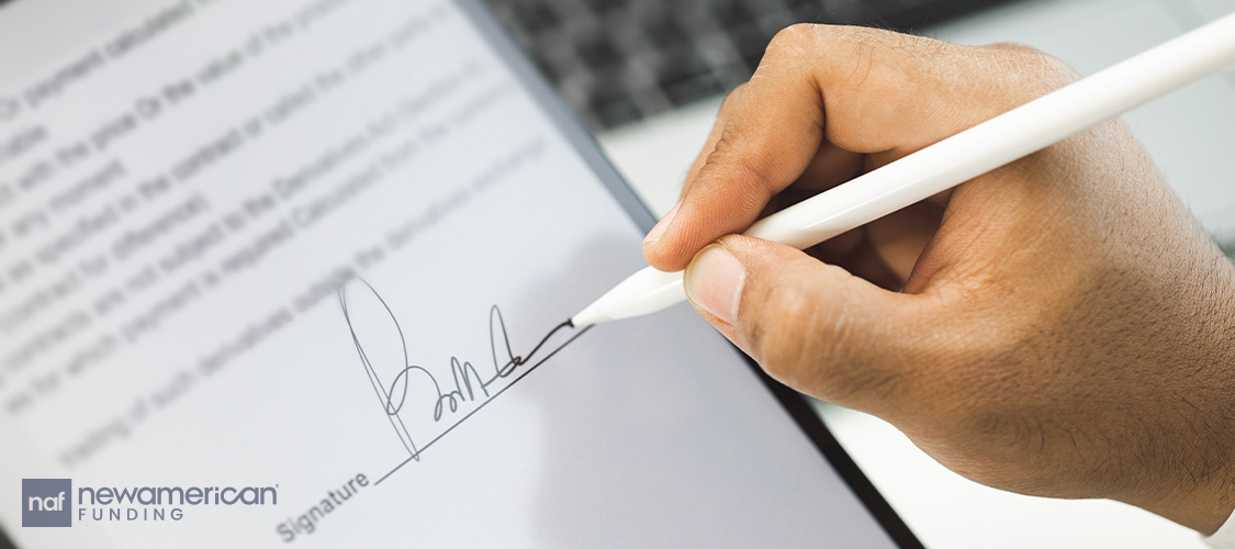 Someone signing a form on a tablet.