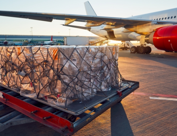 Palet with several boxes getting loaded into cargo plane
