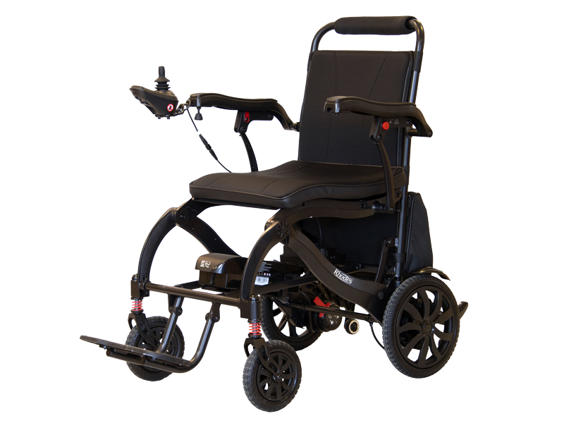 Roma Medical Rhodes powered wheelchair with padded seat and backrest, armrests and joystick control, black frame with small front casters and larger rear wheels, shown on a white background.