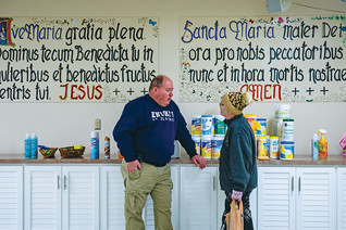 Rich Ferris, in East Palestine, assists a member of the community picking up cleaning supplies