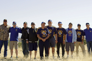 Knights who ran an evacuation site for people displaced by nearby wildfires stand together