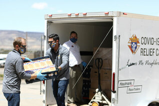 Jeremy Boucher, Lance Tanner and Supreme Director Patrick Mason — all members of Fray Marcos Council 1783 in Gallup — unload a trailer of supplies for the Acoma people in New Mexico.