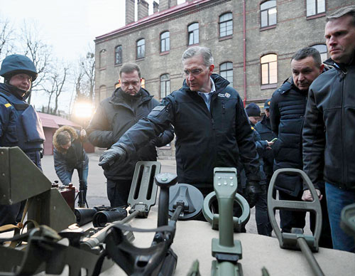 Supreme Knight Patrick Kelly reviews mine detection equipment following a meeting with government officials
