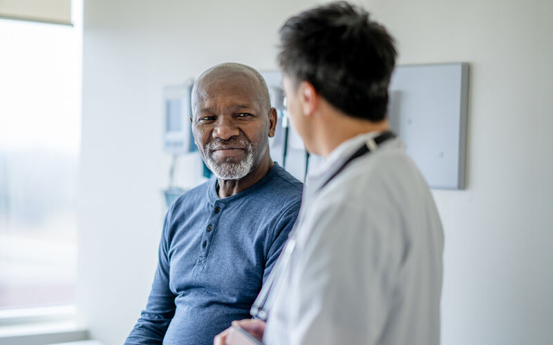 Older male patient getting a medical exam to test for cancer