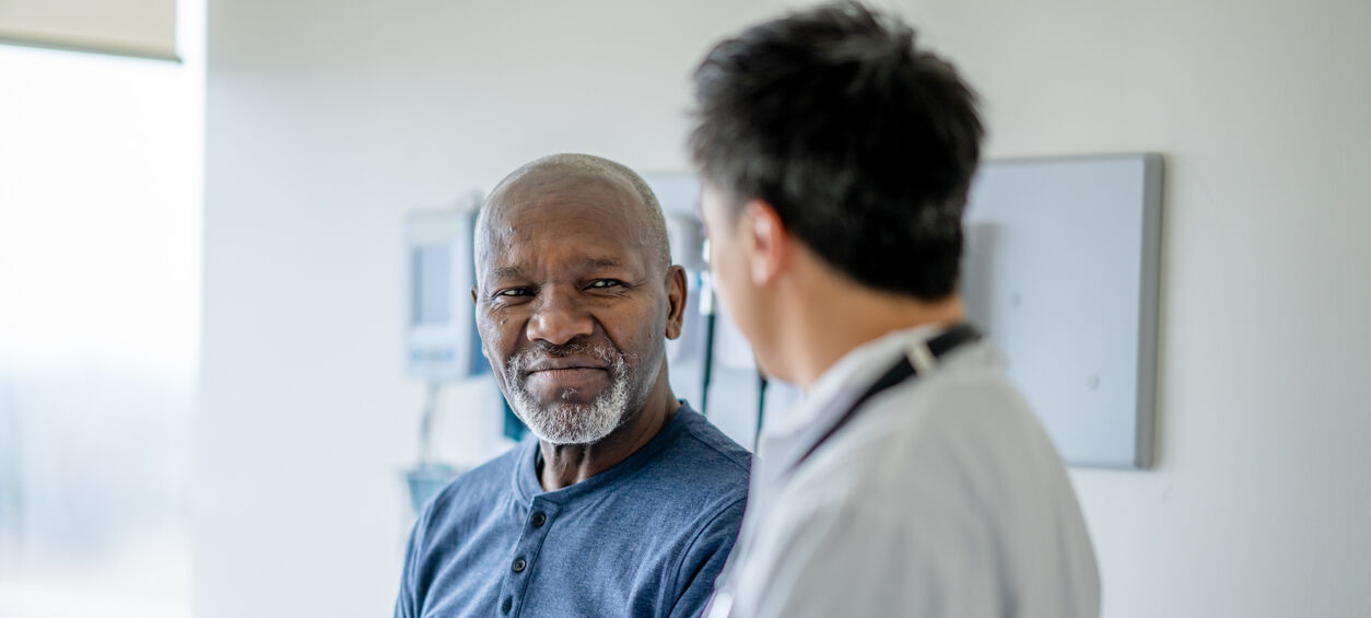 Older male patient getting a medical exam to test for cancer