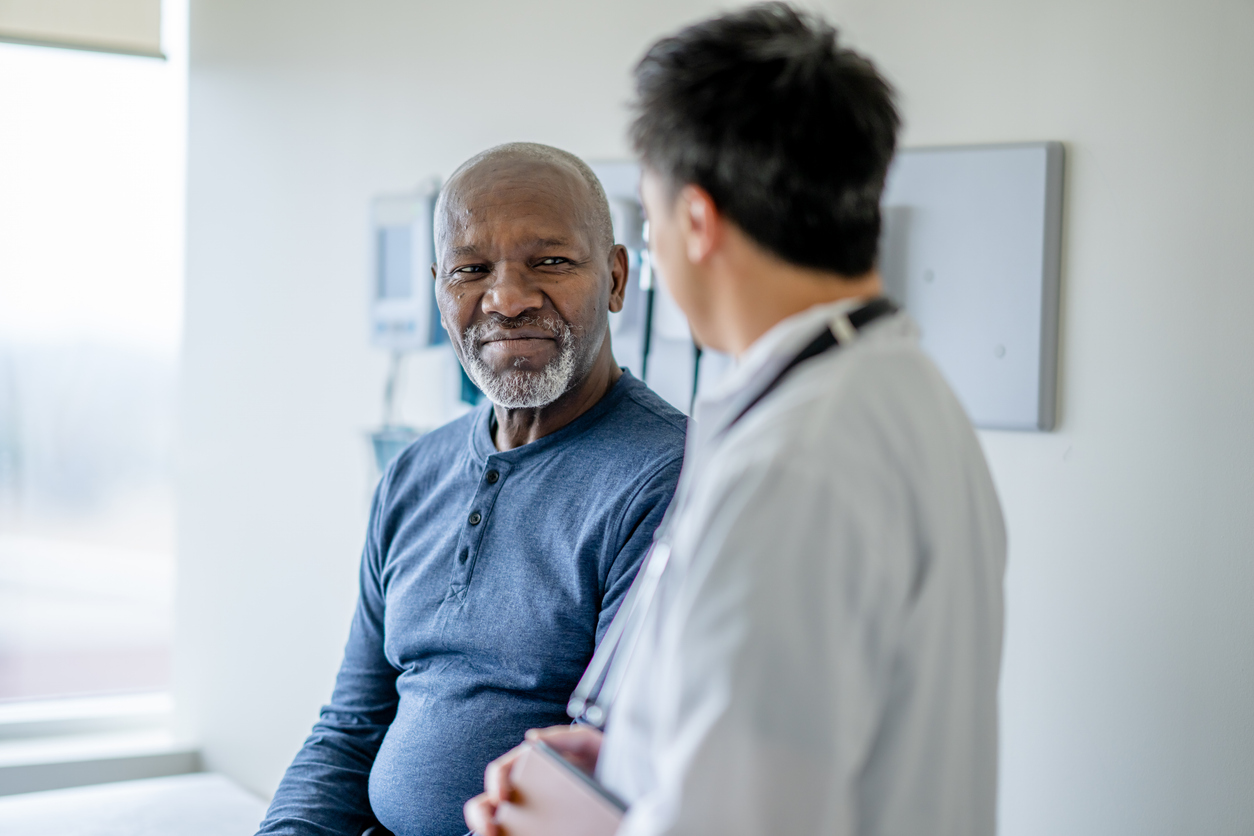 Older male patient getting a medical exam to test for cancer