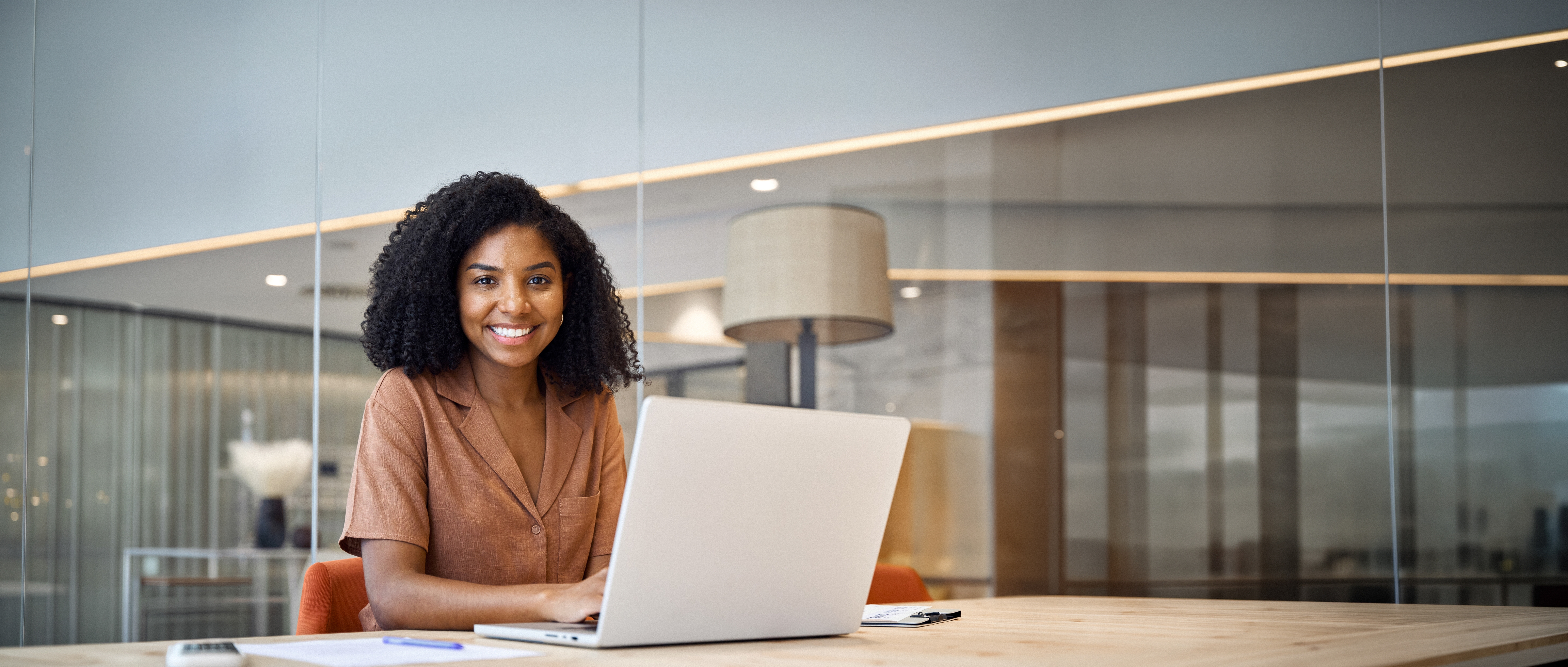 Smiling young woman working on a laptop