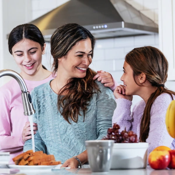mother with daughters in the kitchen