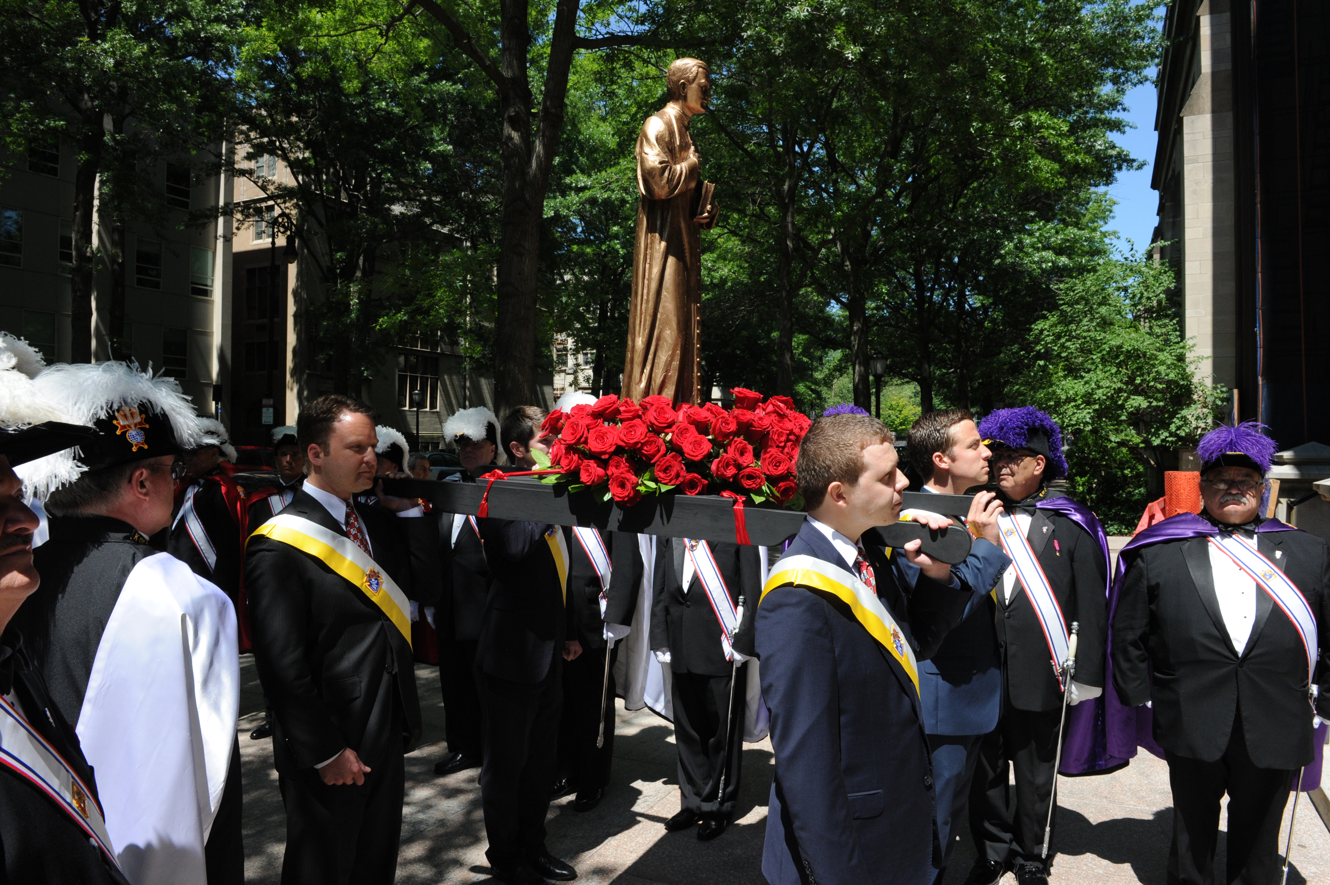 Knights carry a statue of Father McGivney into St. Mary’s Church for the 125th anniversary of the priest’s death in 2015.