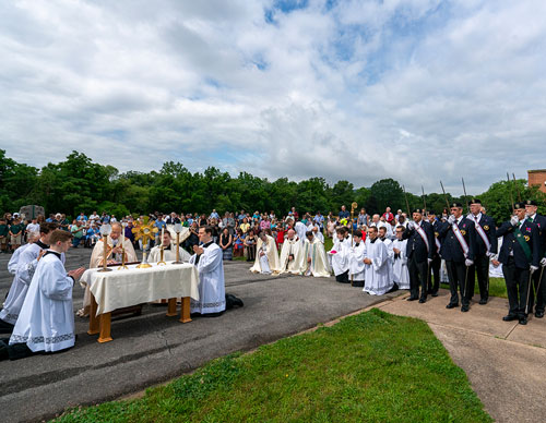 Fourth Degree Knights stand at attention as Supreme Chaplain Archbishop William Lori of Baltimore prays before the Eucharist outside Mother Seton School in Emmitsburg, Md., June 6. Archbishop Lori led a procession in the vicinity of the National Shrine of St. Elizabeth Ann Seton as part of the National Eucharistic Pilgrimage. (Photo by Matthew Barrick)
