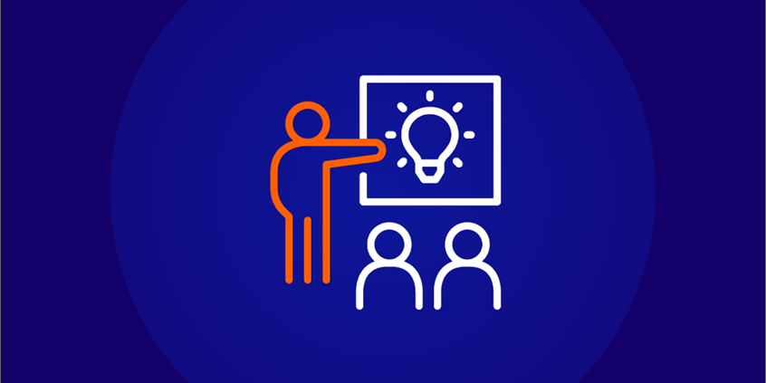 An icon of a person with an orange outline pointing to a board with a lightbulb idea illustration on it, in front of two white outline people sitting down. This represents an exam center, a classroom, or a presentation/teaching session.