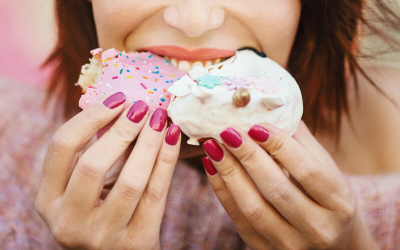women eating sugary treats