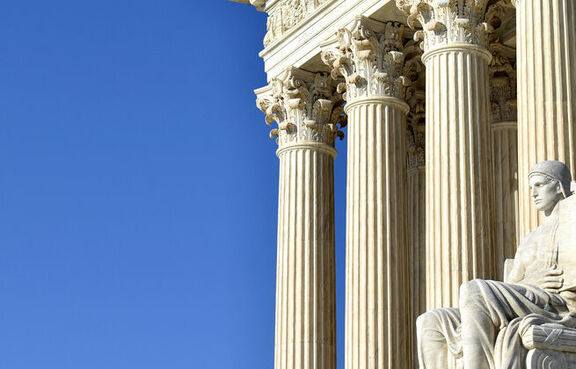 Government building with columns and statue 