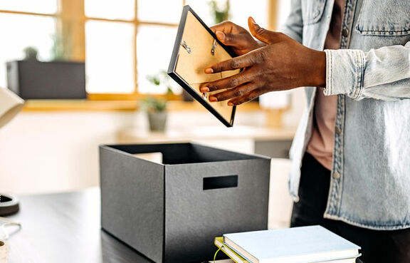 Casual businessman unpacking home office