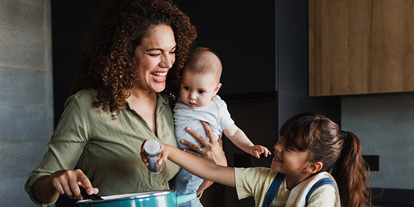 latina mother with her children cooking in the kitchen