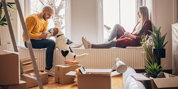 couple in their new home with their dog