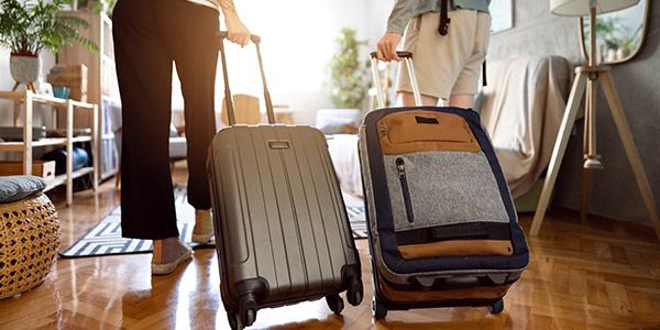 rolling luggages into a living room