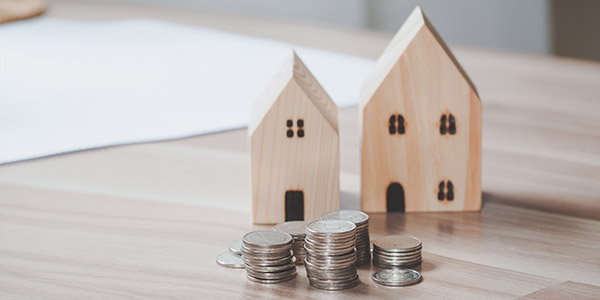 house models and stacks of coins