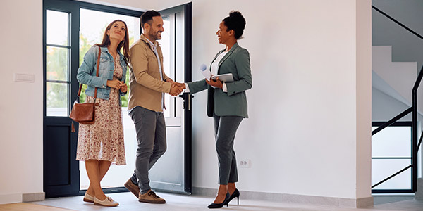 homebuyers meeting their real estate agent at a house showing