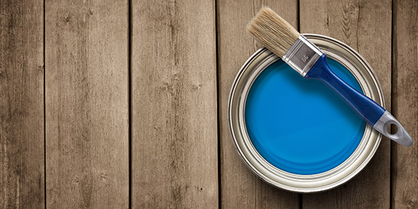 blue paint can with a paint brush