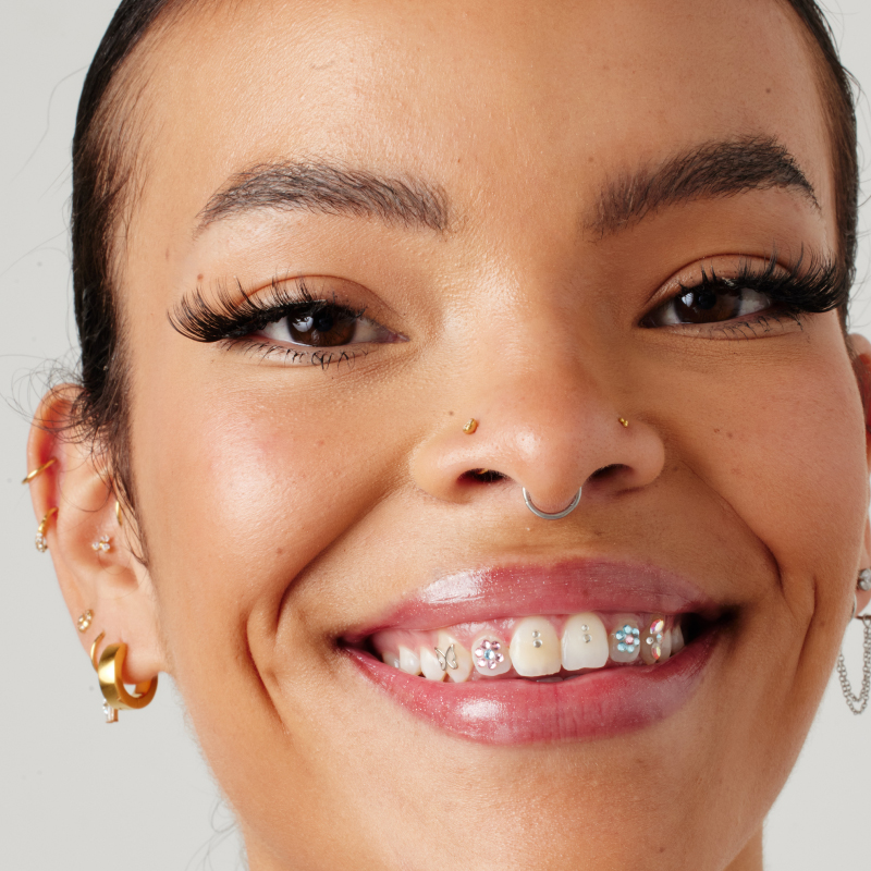 Close up of girls face with nose piercings and ear piercings