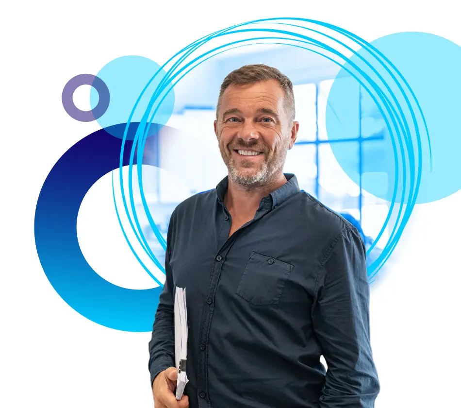 Man standing in front of circles holding a notepad smiling.