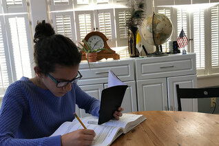 The author’s daughter Maria studies pre-algebra in the family’s school room.