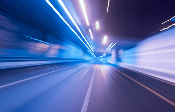 Purple and blue city lights in motion from driver's point-of-view