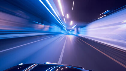 Purple and blue city lights in motion from driver's point-of-view