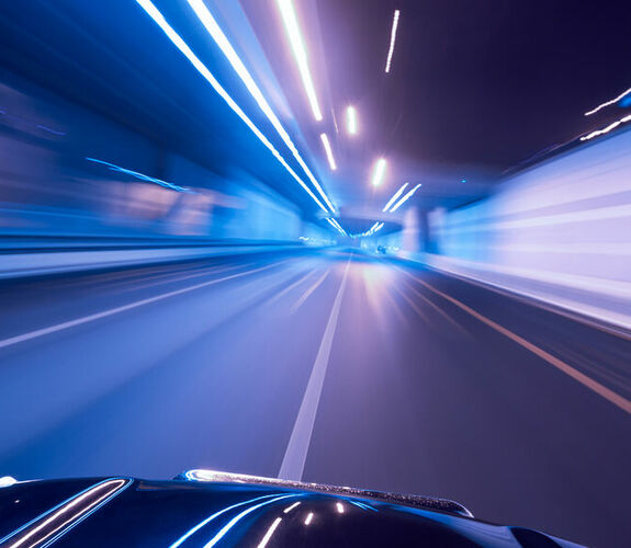 Purple and blue city lights in motion from driver's point-of-view