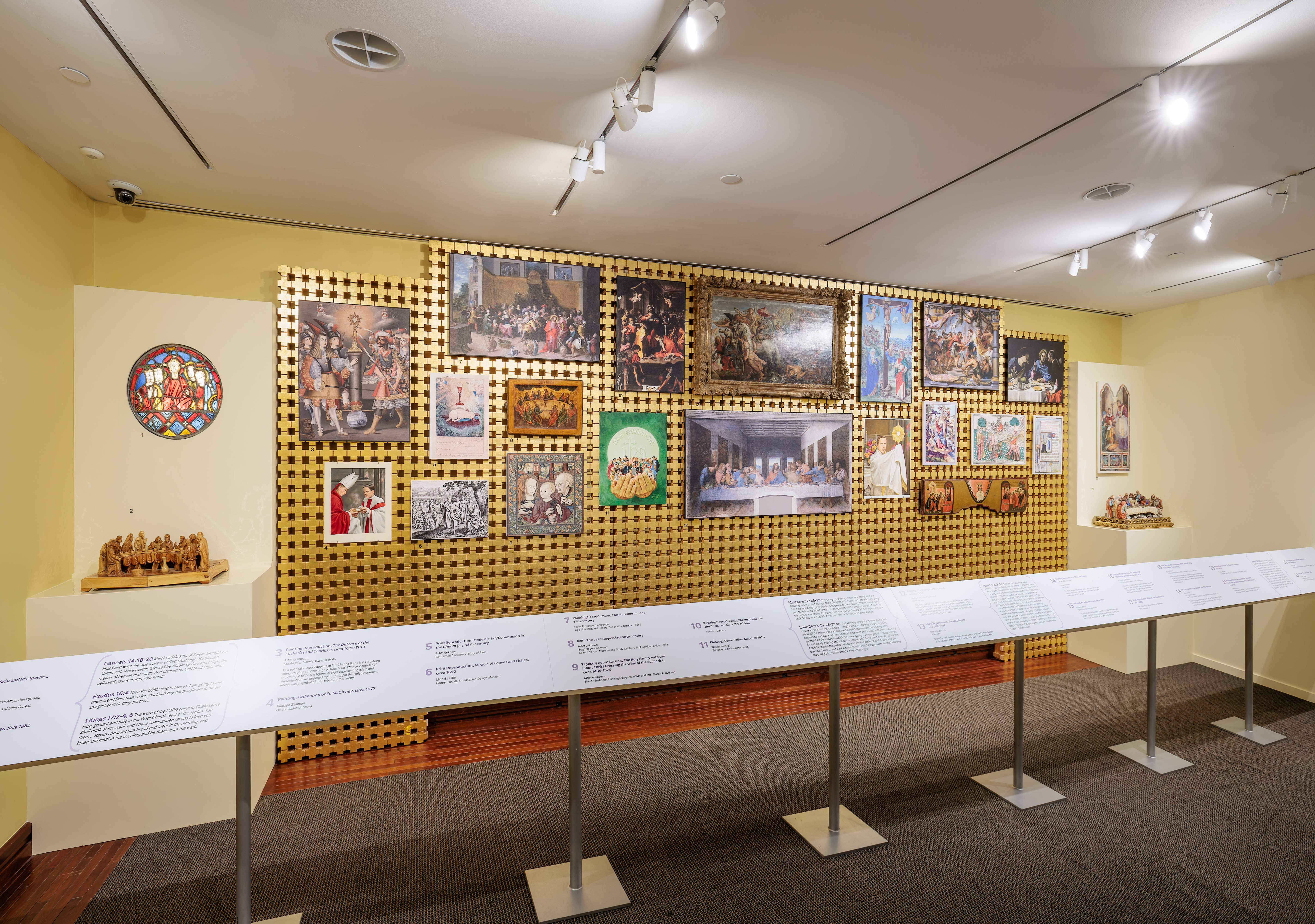 Photo of the temporary exhibit "True Presence: The Eucharist in History and Art." Depicts gallery wall of artwork featuring the Eucharist. 