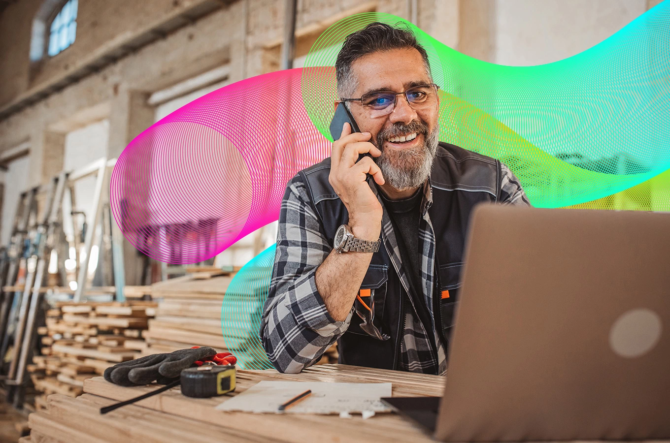 Small business owner on phone while using laptop