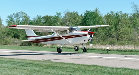 Cessna Skyhawk single engine, piston-driven private airplane, landing at a small county airport. 