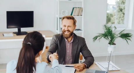 Image of a helpful looking business person at a desk  