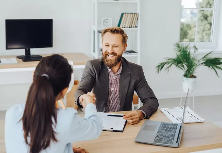 Image of a helpful looking business person at a desk  